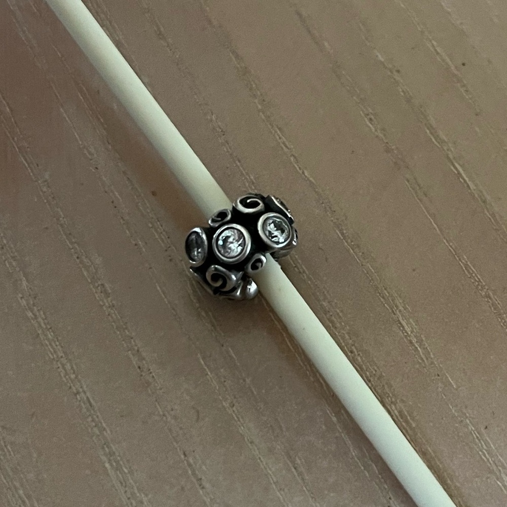 Pandora retired Sterling silver Primrose Path charm with clear CZ stones.